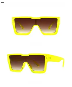Front and 45-degree views of fluorescent green oversized shield sunglasses with tan lenses
