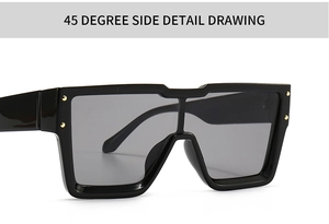 Detail view of black oversized sunglasses with gold rivets and grey mono lens