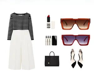 Flat lay of striped top, white wide-leg trousers, and luxury black leather handbag set