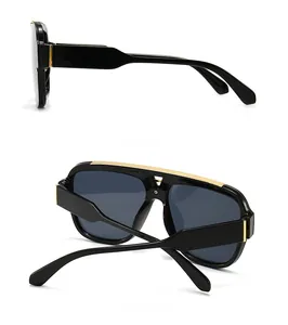 Detailansicht der quadratischen Vintage-Sonnenbrille mit goldenem Steg und Seitenrahmen