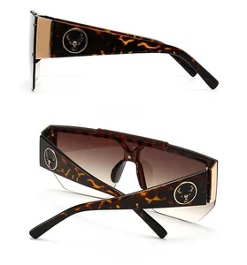 Detailed side and back view of tortoiseshell sunglasses with golden deer head logo accent