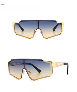 Detail view of gold oversized metal sports sunglasses with gradient blue tan lenses