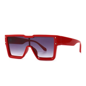 Oversized square red sunglasses with gradient lenses and gold rivet accents on white background