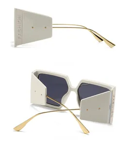 Detail view of cream white square frame sunglasses with gold temples and side guards
