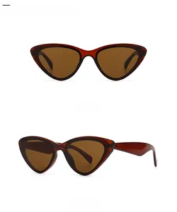 Détail de lunettes de soleil rétro œil de chat, monture bordeaux et verres marron