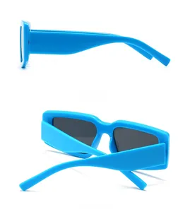 Detail view showing side temple curve and back folding of blue rectangular sunglasses