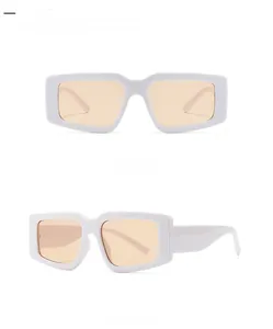 Detail view of white thick-frame retro rectangle sunglasses with light tan lenses
