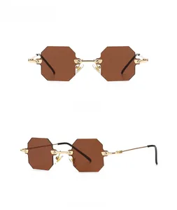 Close-up of modern octagon sunglasses with gold metal frame and gold tan lenses