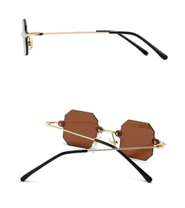 Detail view of gold metal temples and brown octagonal rimless sunglasses from side and back