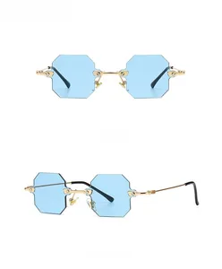 Detail view showing frameless octagonal sunglasses with gold metal frame and blue lenses