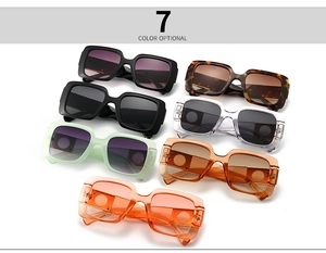 Flat lay of square sunglasses in seven colors including black, tortoise, and pastel tones