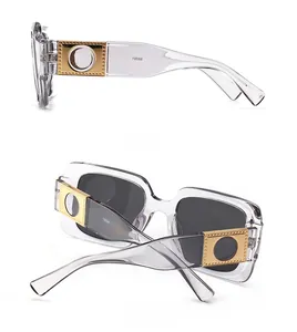 Macro detail of square sunglasses with grey frames and golden metal temple hinges