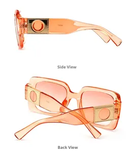 Detail of orange square sunglasses showing golden metal hinges and gradient lenses
