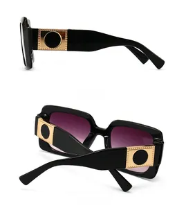 Detail of square sunglasses with gold metal temples and gradient purple lenses