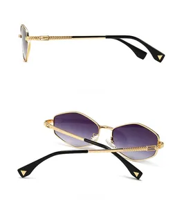 Detail view of gold sunglasses with purple gradient lenses and woven FF logo on temples