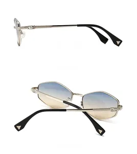Detail view of gold geometric frame sunglasses showing side hinge and back design