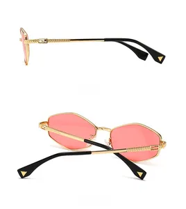 Detailed view of golden hexagonal sunglasses featuring hollow FF logo on the temples