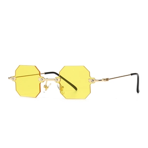 Modern octagonal narrow sunglasses with yellow lenses and golden metal frames for women