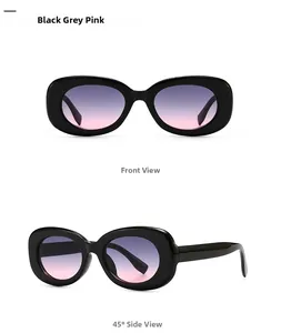 Detail view of retro oval sunglasses featuring black frames and grey pink gradient lenses