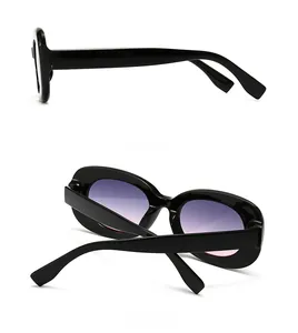 Detail view of thick black frame sunglasses with gradient purple lenses showing side and back