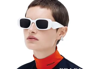 Detail of white rectangle sunglasses with geometric temple design and dark lenses