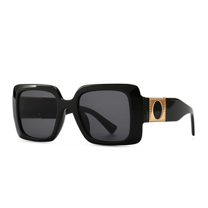 Modern vintage oversized square sunglasses with black frames and gold metal accents