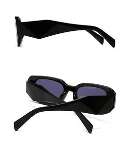 Detail view showing side and back of black rectangular sunglasses with geometric temples