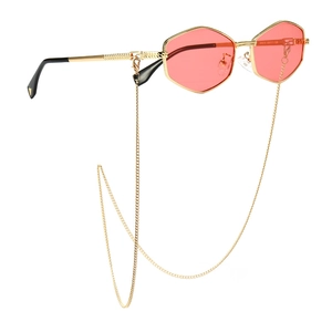 Retro hexagonal gold metal sunglasses with pink lenses and attached chain accessory
