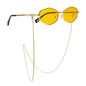 Modern hexagonal gold sunglasses with yellow lenses and matching decorative chain strap