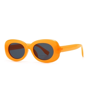 Modern retro oval sunglasses with thick bright orange frames and dark grey tinted lenses