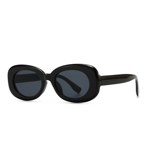 Modern retro black oval sunglasses with thick frames and dark lenses for street style
