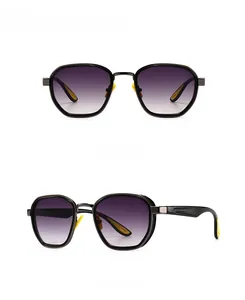 Detail view of gunmetal geometric sunglasses with double grey gradient lenses and yellow accents
