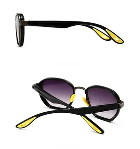 Detail view of modern sunglasses showing black frame with purple gradient lenses and yellow pads