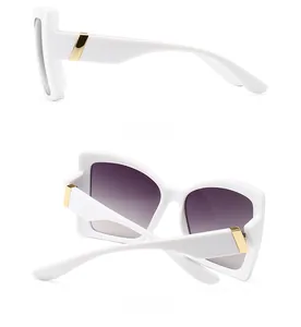 Detail view of white sunglasses featuring gold metal temples and purple gradient lenses