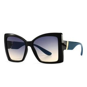 Modern oversized cat-eye sunglasses with black frames and gradient blue lenses