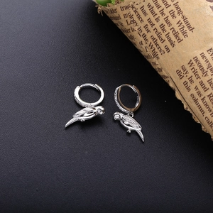 Macro shot of S925 sterling silver parrot earrings with zircon inlay and hallmark