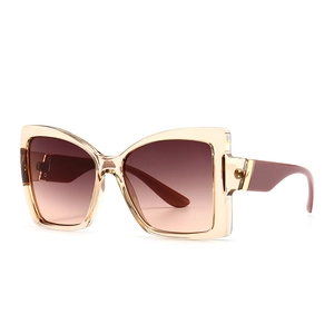Modern cat-eye sunglasses with champagne frames and brown gradient lenses for women
