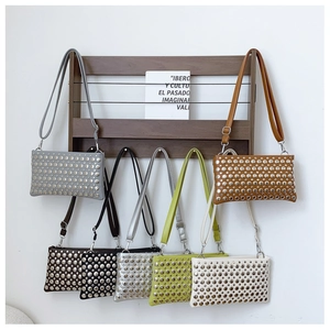 Close-up of stylish PU leather shoulder bags featuring silver metal rivet decorations