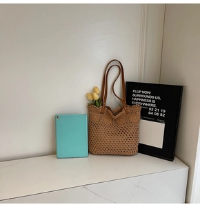 Detailed view of handmade crochet tote bag with round floral patterns and leather straps