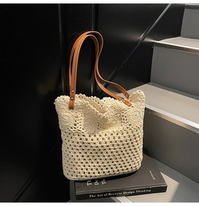 Detail of crochet tote bag with mesh floral patterns and brown leather handles