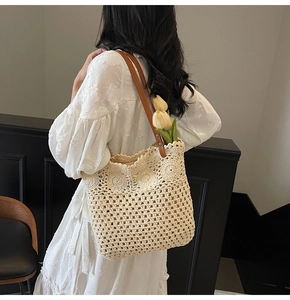 Close-up of handmade crochet tote bag with hollow geometric patterns and leather straps