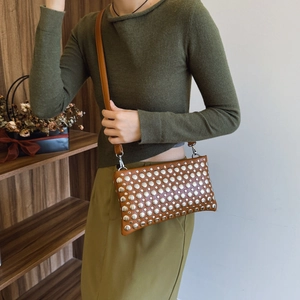 Brown punk rivet shoulder bag in vintage leather with silver studs and slim strap