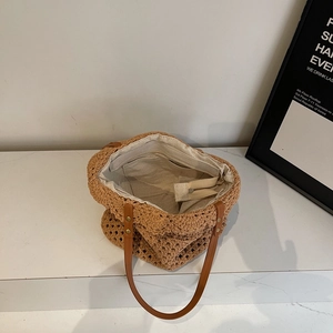 Handwoven hollow crochet tote bag with brown faux leather handles for summer beach travel