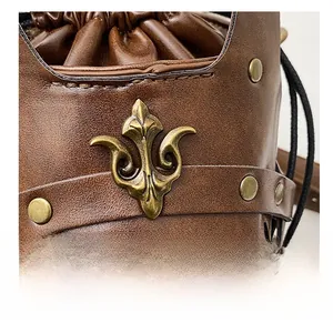 Macro detail of brown leather bag with vintage brass rivets and relief metal decoration