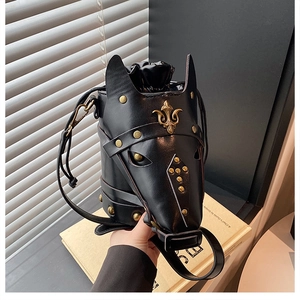 Detail of horse-head bucket bag with gold fleur-de-lis emblem and metallic studs