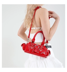 Détail d'un sac à main rouge brillant avec boucles métalliques et style vintage Y2K