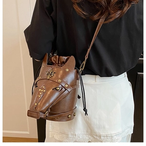 Detail of horse-head bucket bag showing metal studs and leather craftsmanship