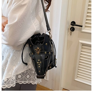 Detail of black leather horse mask bucket bag with gold studs and drawstring closure