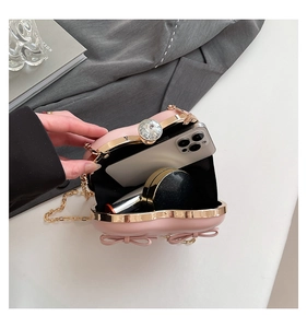 Detail showing the internal storage capacity of the pink heart clutch bag with accessories