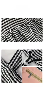 Detailed view of checkered canvas bag featuring metal zipper pocket and drawstring closure